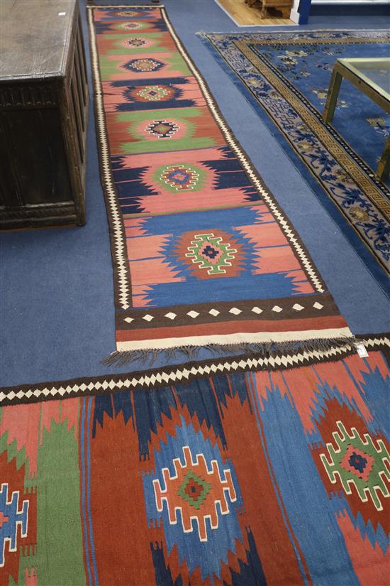 A Kelim long runner, with multi-coloured geometric design, a similar rug and a similar small rug